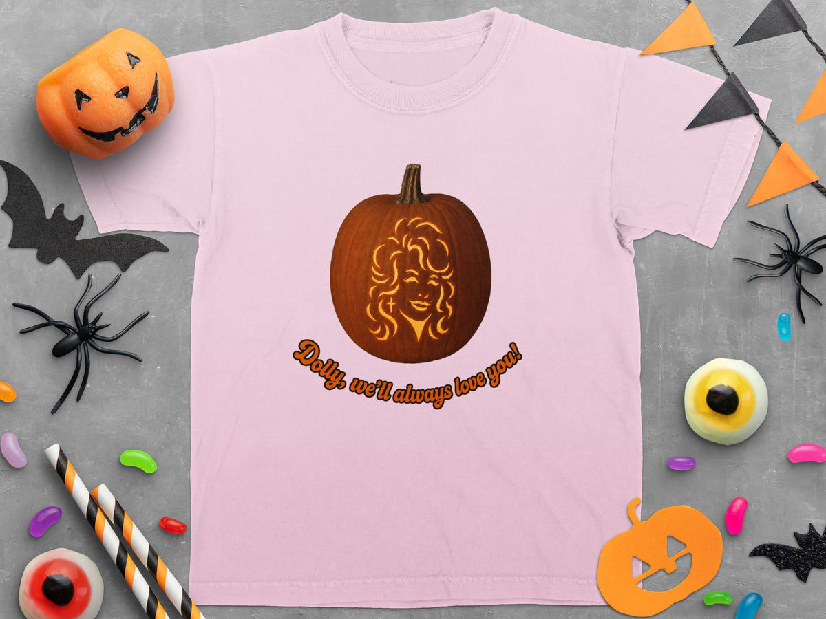 Pink t-shirt with a carved pumpkin featuring Dolly Parton and text.