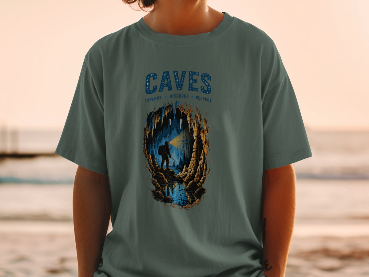 T-shirt with "CAVES" text and illustration of a caver exploring a cave.