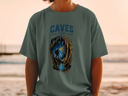 T-shirt with "CAVES" text and illustration of a caver exploring a cave.