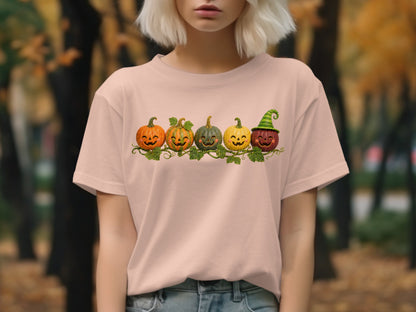 Five smiling jack-o'-lanterns with a green striped hat on the last one.