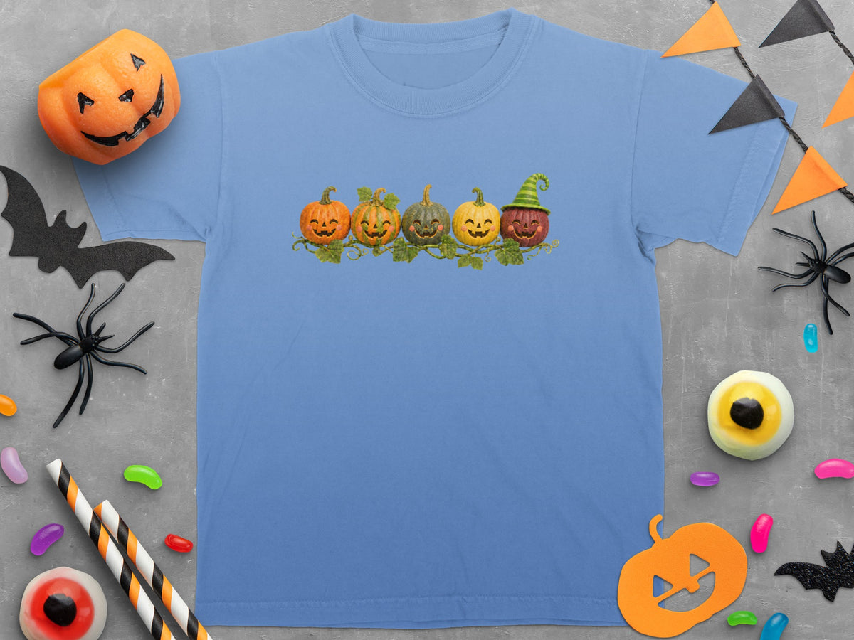 Light blue t-shirt with five smiling pumpkins and a Halloween-themed border.