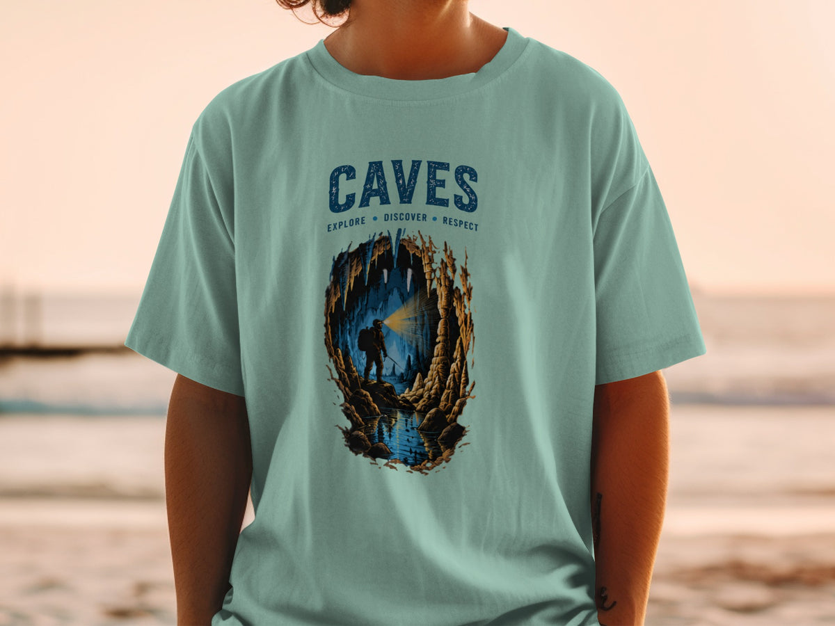 T-shirt with "CAVES EXPLORE DISCOVER RESPECT" graphic and cave explorer illustration.