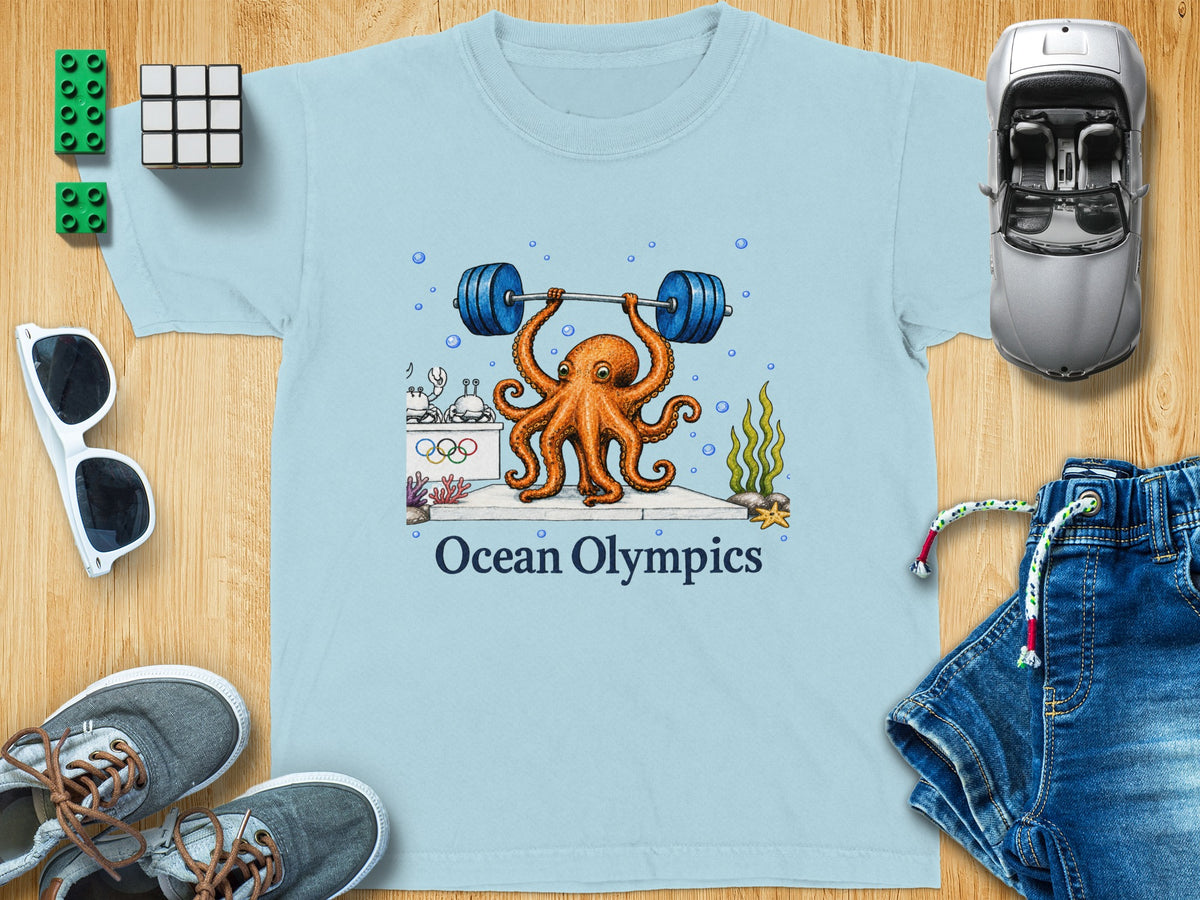 Light blue t-shirt featuring an octopus lifting a barbell, with "Ocean Olympics" text.
