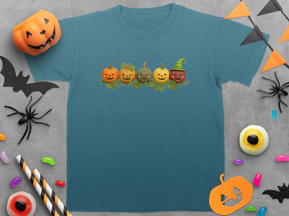 Teal t-shirt with a line of five smiling pumpkins graphic.