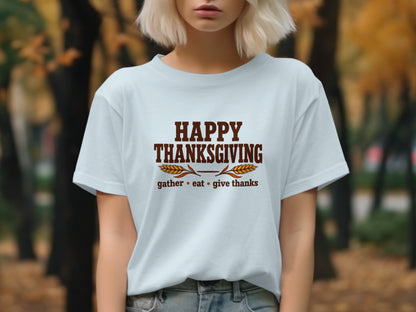 Light blue t-shirt with "Happy Thanksgiving" and "gather eat give thanks" text.
