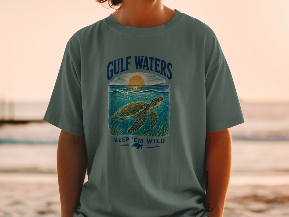 T-shirt graphic: "Gulf Waters" text, sea turtle swimming, sunset over ocean.