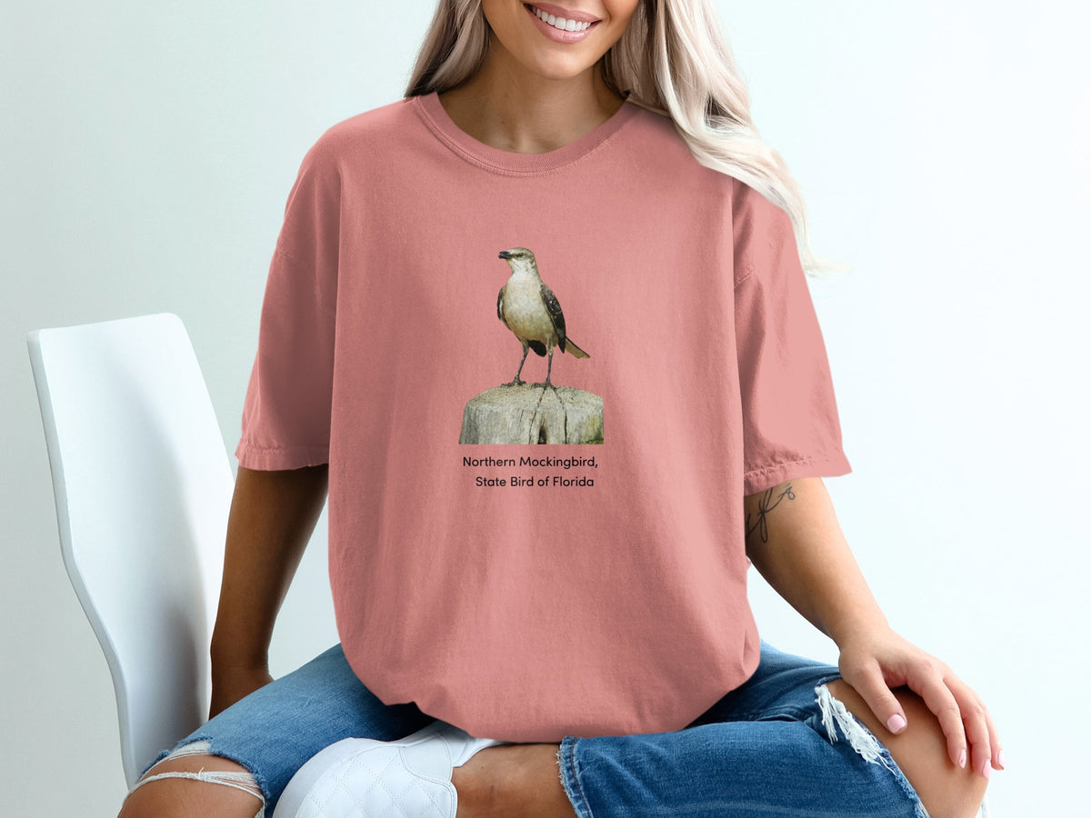 Northern Mockingbird, State Bird of Florida graphic on a pink shirt.