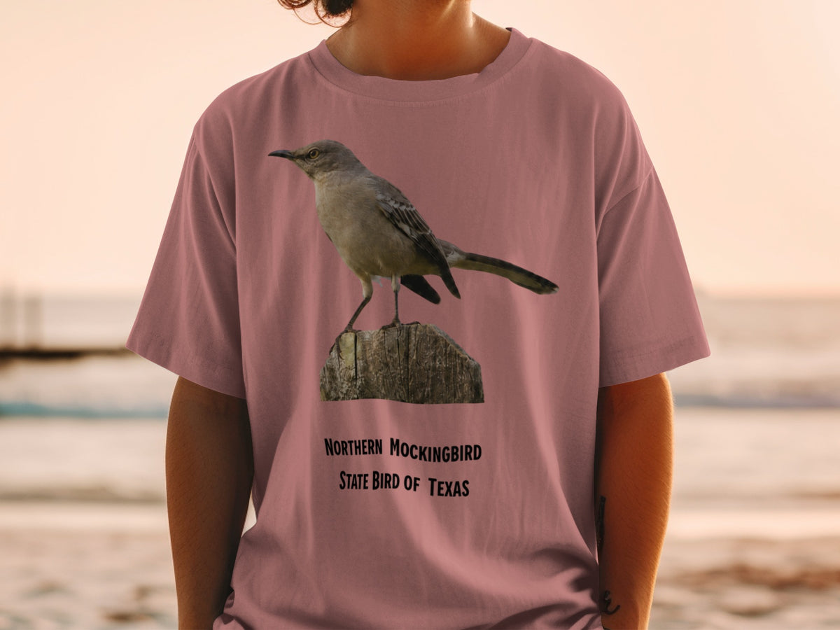 Northern Mockingbird, State Bird of Texas graphic on a rose t-shirt.