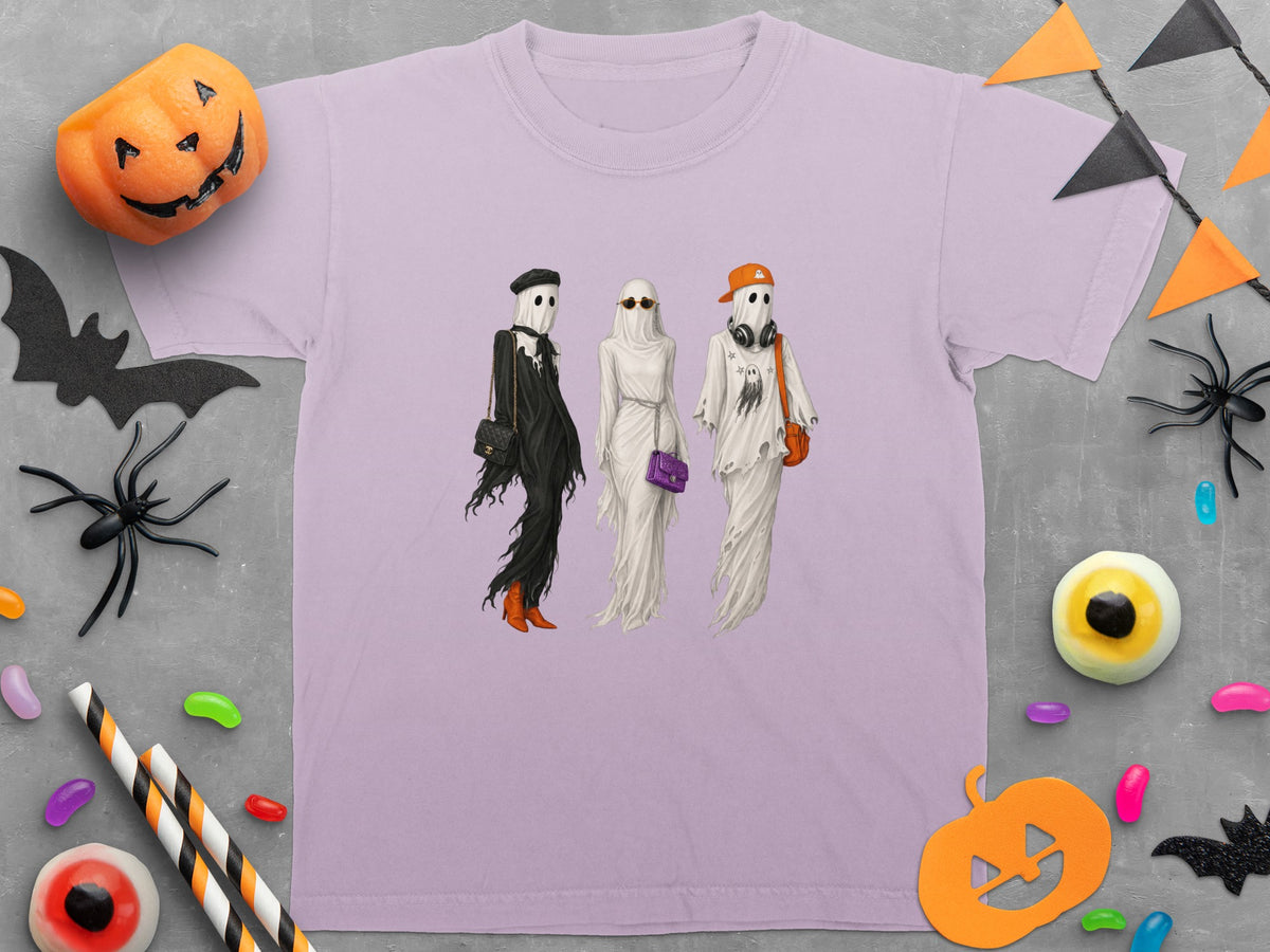 Lilac t-shirt with three ghosts in fashion attire and Halloween decorations.
