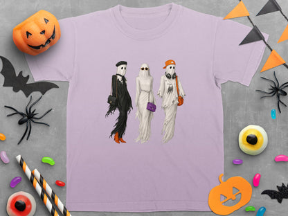 Lilac t-shirt with three ghosts in fashion attire and Halloween decorations.