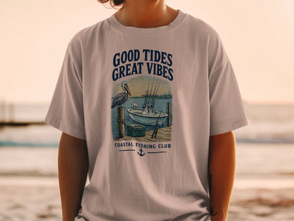 T-shirt with "Good Tides Great Vibes" graphic featuring a pelican, fishing boat, and dock.