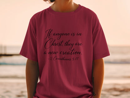 Maroon t-shirt with black text "If anyone is in Christ, they are a new creation. -2 Corinthians 5:17"