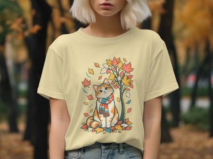Orange tabby cat with scarf sits amongst fall leaves under a tree.