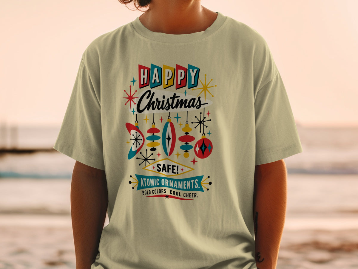 T-shirt graphic with "HAPPY Christmas" and "ATOMIC ORNAMENTS" in retro style.