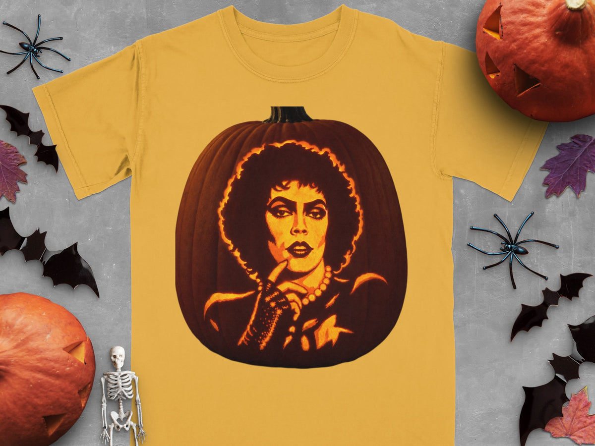 Gold t-shirt featuring a lit jack-o-lantern carved with Dr. Frank-N-Furter, surrounded by Halloween decorations.