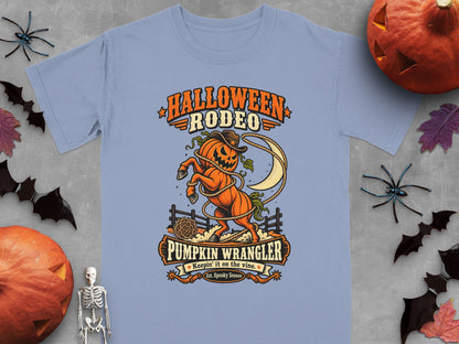 Light blue t-shirt with "Halloween Rodeo Pumpkin Wrangler" design.