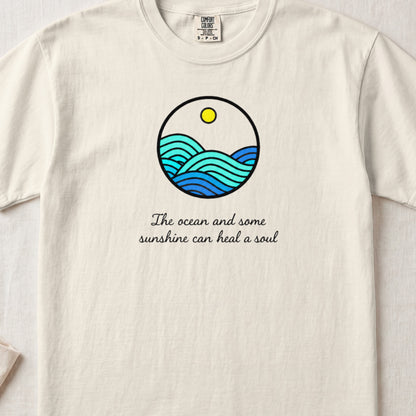 Off-white crewneck t-shirt featuring a circular ocean graphic and the text The ocean and some sunshine can heal a soul.