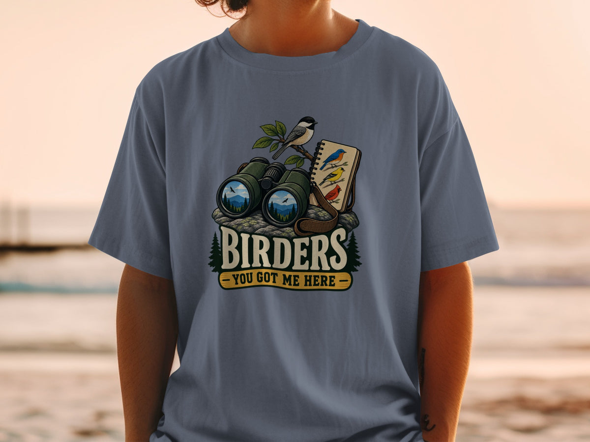 Binoculars, a bird on a branch, and bird illustrations on a notebook, with text "BIRDERS".