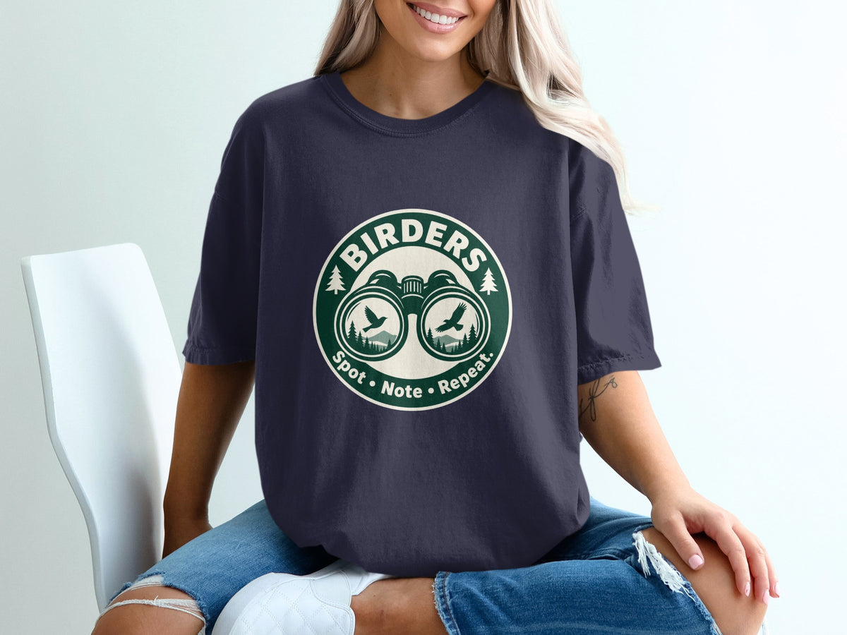 Navy t-shirt with circular graphic of binoculars, birds, trees, and text "Birders Spot • Note • Repeat."