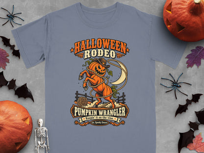 Halloween Rodeo Pumpkin Wrangler graphic with cowboy pumpkin on a gray t-shirt.