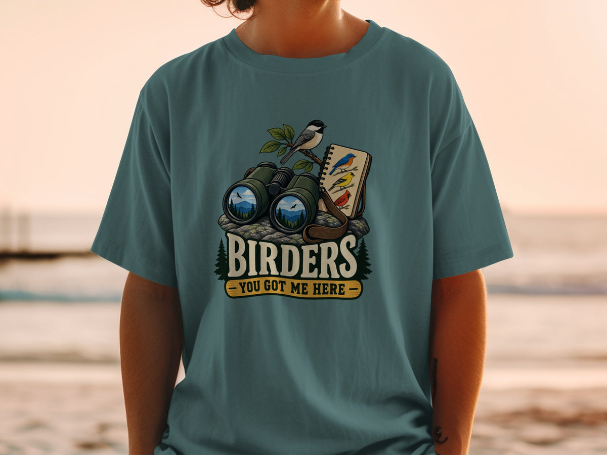 T-shirt with graphic of binoculars, birds, and text "Birders - You Got Me Here".