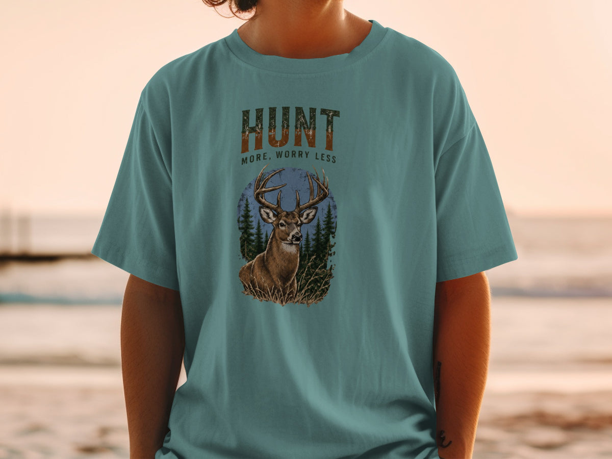 Teal t-shirt with deer graphic and text "HUNT MORE, WORRY LESS".