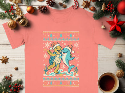 A coral shirt with a Christmas sweater design featuring a joyful turtle and dolphin.