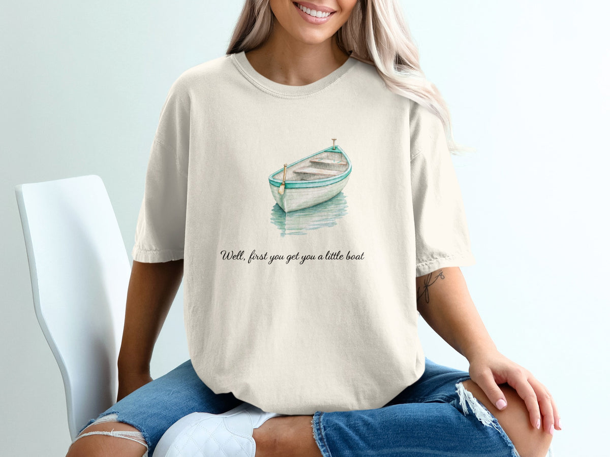 T-shirt with watercolor boat graphic and text "Well, first you got you a little boat".