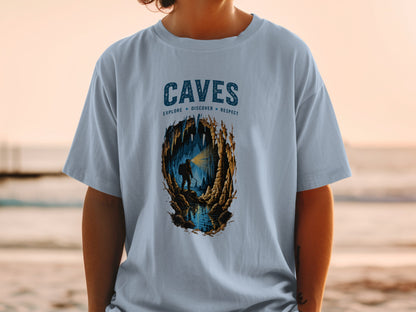 Light blue t-shirt with "CAVES EXPLORE DISCOVER RESPECT" and cave explorer graphic.