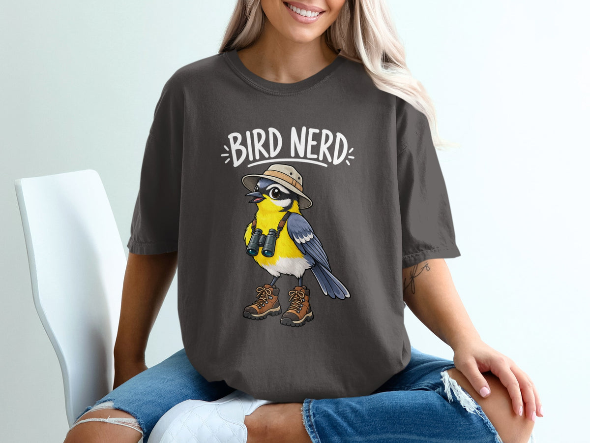 Dark grey t-shirt with a cartoon bird wearing a hat, binoculars, and boots. Text says "BIRD NERD".