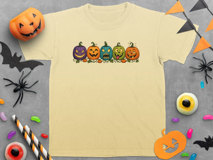 T-shirt with five cartoon pumpkins with different expressions, Halloween decorations.