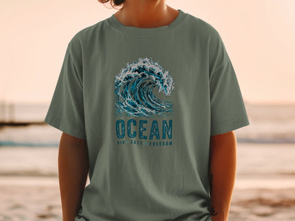T-shirt with a crashing wave graphic and text "OCEAN AIR SALT FREEDOM".