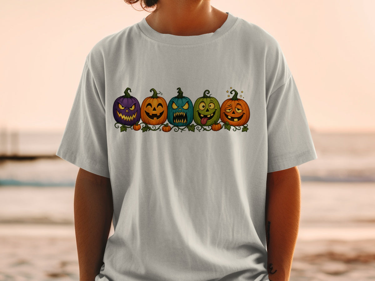 Five cartoon pumpkins with different spooky faces are lined up on a vine.
