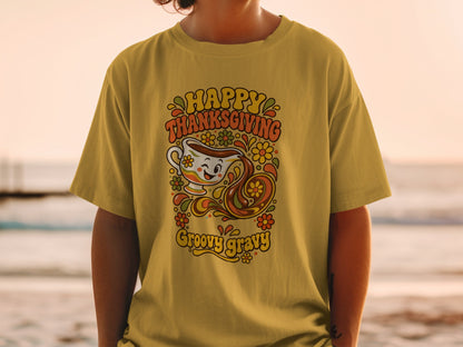 Yellow t-shirt with "Happy Thanksgiving Groovy Gravy" text and retro gravy boat graphic.