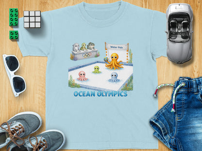 Light blue t-shirt with a graphic of octopuses playing water polo with the text "OCEAN OLYMPICS".