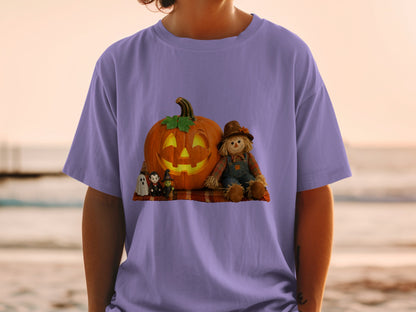 Purple t-shirt with Halloween design featuring a jack-o'-lantern, scarecrow, witch, vampire, and ghost.