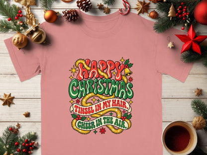 Pink t-shirt with "Happy Christmas, Tinsel in my hair, Cheer in the air" graphic.