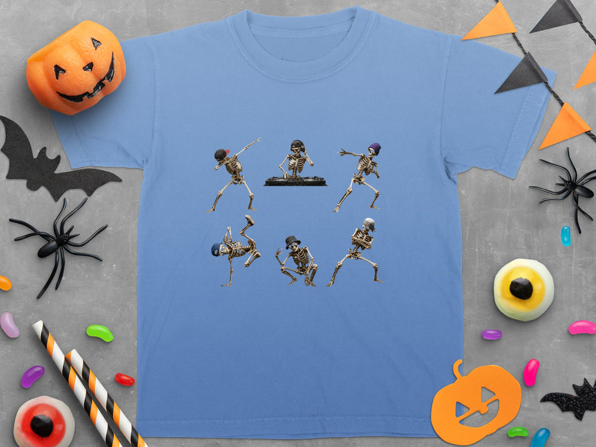 Blue t-shirt with six dancing skeletons, Halloween decorations, and candy scattered around.