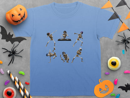 Blue t-shirt with six dancing skeletons, Halloween decorations, and candy scattered around.