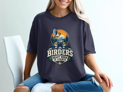 Graphic tee with binoculars, bird, and mountains; text reads "BIRders READY WHEN IT STARTS".