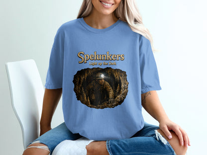 "Spelunkers Light up the Dark" text above a caver in a cave graphic.