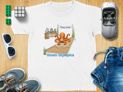 White t-shirt with cartoon octopus competing in a long jump at Ocean Olympics.