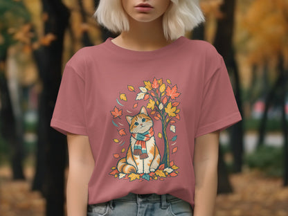 T-shirt with a graphic of a cat wearing a scarf under a tree with autumn leaves.