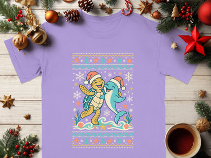 Purple t-shirt with cartoon turtle and dolphin wearing Santa hats.
