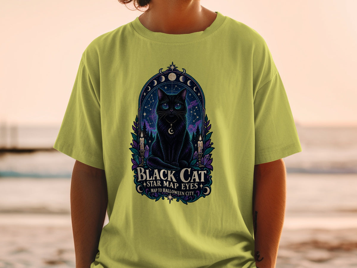 Black cat with star map eyes on a t-shirt, featuring celestial and Halloween imagery.