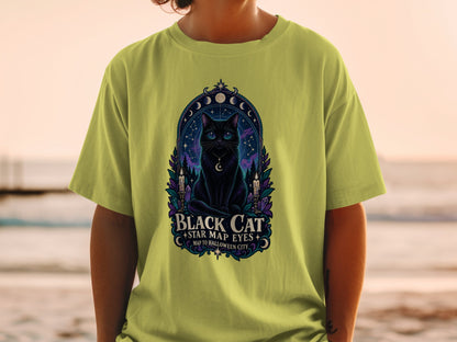 Black cat with star map eyes on a t-shirt, featuring celestial and Halloween imagery.