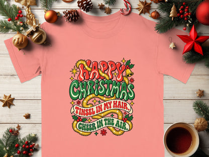 Pink t-shirt with "Happy Christmas" and "Tinsel in my hair, cheer in the air" graphic.