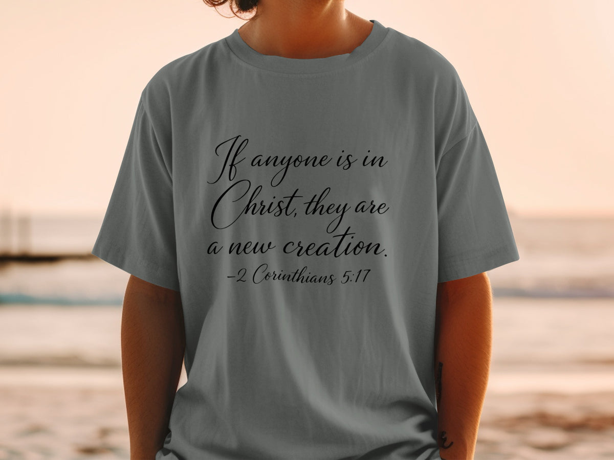 Grey t-shirt with text "If anyone is in Christ, they are a new creation. -2 Corinthians 5:17"