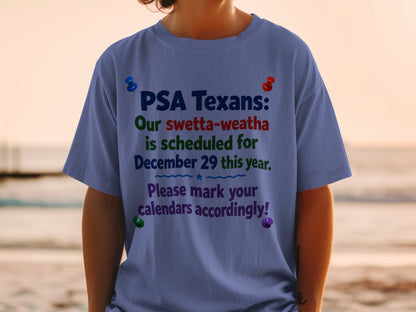 Blue t-shirt with text: "PSA Texans: Our swetta-weatha is scheduled for December 29 this year. Please mark your calendars accordingly!"