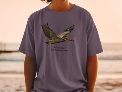 Brown Pelican, State Bird of Louisiana graphic on a purple t-shirt.